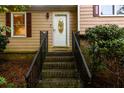 Stairway leading to the front door with a decorative glass window at 4324 Japonica Sw Ct, Lilburn, GA 30047
