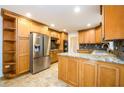 Spacious kitchen with wooden cabinets, tile flooring, and stainless steel refrigerator at 4324 Japonica Sw Ct, Lilburn, GA 30047