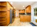 A bright kitchen featuring wooden cabinetry, stainless steel appliances, and beautiful granite countertops at 4324 Japonica Sw Ct, Lilburn, GA 30047
