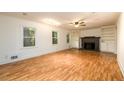 Spacious living room with wood floors, built-in shelving, a fireplace, and large windows at 4324 Japonica Sw Ct, Lilburn, GA 30047