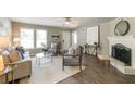 Comfortable living room with a fireplace, soft lighting, and neutral color palette at 4408 Brandon Ne Ct, Marietta, GA 30066