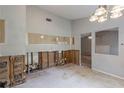 A bare kitchen with studs and exposed pipes, next to a living space, ready for renovation and customization at 5856 Rock Rd, Union City, GA 30291