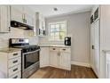 Well-equipped kitchen featuring stainless steel appliances, ample counter space, and white cabinets with sleek hardware at 604 Continental Dr, Lawrenceville, GA 30044