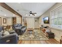 Spacious living room featuring lots of natural light, hardwood floors, a ceiling fan, and a comfortable seating area at 604 Continental Dr, Lawrenceville, GA 30044