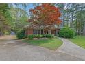 Beautiful brick home with a manicured lawn and walkway at 148 Hurt Road Sw, Smyrna, GA 30082