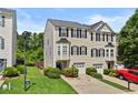 Charming townhome featuring a well-manicured lawn, one-car garage, and traditional design at 1608 Indian Way, Cumming, GA 30040