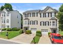 Charming townhome featuring a well-manicured lawn, one-car garage, and traditional design at 1608 Indian Way, Cumming, GA 30040