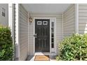 Inviting front door with a welcoming mat and charming details at 1608 Indian Way, Cumming, GA 30040