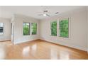 Bright bedroom featuring hardwood floors and large windows with green views at 3621 Vinings Slope Se # 3510, Atlanta, GA 30339