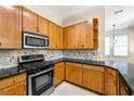 Well-lit kitchen features granite countertops, stainless steel appliances, and light wood cabinetry at 3621 Vinings Slope Se # 3510, Atlanta, GA 30339