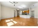 Spacious living room featuring hardwood floors and a view of the kitchen at 3621 Vinings Slope Se # 3510, Atlanta, GA 30339
