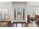 Inviting foyer features an ornate front door and shuttered windows at 5285 Winflow Way, Suwanee, GA 30024
