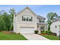Charming two-story home with a manicured lawn and a two-car garage, offering curb appeal at 6360 Boulder Rdg, Cumming, GA 30028