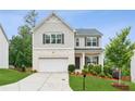 Charming two-story home with a manicured lawn and a two-car garage, offering curb appeal at 6360 Boulder Rdg, Cumming, GA 30028