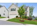 Charming two-story home with a manicured lawn and a two-car garage, offering curb appeal at 6360 Boulder Rdg, Cumming, GA 30028