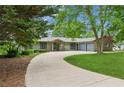 Ranch-style home with three-car garage, manicured landscaping and an asphalt drive at 2055 Cactus Ln, Cumming, GA 30040