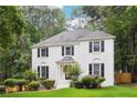 Beautiful two-story white brick home featuring black shutters and a professionally landscaped front yard at 2745 Saxon Drive, Duluth, GA 30096