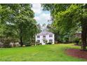 Well-maintained front yard featuring a lush green lawn and beautiful shade trees surrounding the home at 2745 Saxon Drive, Duluth, GA 30096