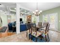 Stylish dining room with coffered ceilings, decorative chandelier, and views into living area at 4715 Northridge Dr, Cumming, GA 30040