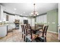 Bright kitchen features white cabinets, granite countertops, and an island with seating at 4715 Northridge Dr, Cumming, GA 30040
