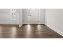 Bright entryway featuring dark hardwood flooring, white walls with wainscoting, and a front door with sidelights at 7169 Linden Dr, South Fulton, GA 30349
