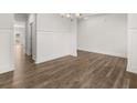 Spacious dining area features hardwood floors, wainscotting detail, and stylish chandelier at 7171 Linden Dr, South Fulton, GA 30349
