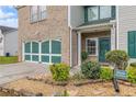 Inviting two-story home with brick and vinyl siding, featuring a charming front entrance and landscaping at 3210 Avondale Pkwy, Powder Springs, GA 30127