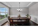 Bright dining room with hardwood floors, wainscoting, and a large window at 3920 Baverton Dr, Suwanee, GA 30024