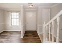 Bright entryway with wood floors, white trim, and staircase leading to the upper level at 5461 Park S Pl, Atlanta, GA 30349