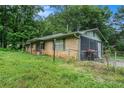 Side view of brick home with a fenced yard and a screened-in back porch at 2087 Chestnut Way, Lithia Springs, GA 30122
