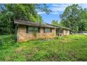 Back view of brick home with a fenced yard and green windows at 2087 Chestnut Way, Lithia Springs, GA 30122