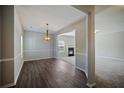 Dining room with wood floors, large window, stylish light fixture, and fireplace view at 3223 Tallon Sw Ln, Atlanta, GA 30311