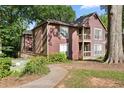 Charming home exterior featuring wood siding, walkways, and mature trees at 5555 Mountain Springs Cir, Stone Mountain, GA 30088