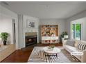 Cozy living room featuring a fireplace, bright decor and hardwood floors at 219 Cobblestone Trl, Avondale Estates, GA 30002