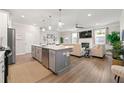 Open-concept kitchen with a large island, stainless steel appliances, and hardwood floors at 3610 Silvery Way, Powder Springs, GA 30127