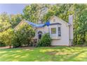 Inviting home featuring a lush front yard, mature trees, and charming exterior details at 42 Breckenridge Dr, Powder Springs, GA 30127
