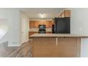 Functional kitchen with wooden cabinets, modern appliances, and an island counter for casual dining at 42 Breckenridge Dr, Powder Springs, GA 30127
