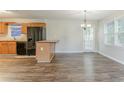 Bright kitchen features black appliances, light-colored cabinets, and wood-style flooring at 42 Breckenridge Dr, Powder Springs, GA 30127