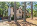 A cozy two-story home features an attached garage and well-maintained landscaping at 142 Wellspring Pt, Hiram, GA 30141