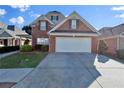Beautiful two-story brick home featuring a spacious driveway and attached two-car garage at 1885 Hickory Station Cir, Snellville, GA 30078