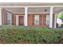 Inviting front porch with classic white columns and well-maintained landscaping at 1885 Hickory Station Cir, Snellville, GA 30078