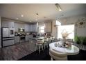 Modern kitchen features stainless appliances, gray cabinets, kitchen island and breakfast bar seating at 5663 Eternal Dr, Atlanta, GA 30349