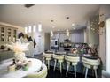 Modern kitchen features stainless appliances, gray cabinets, kitchen island and breakfast bar seating at 5663 Eternal Dr, Atlanta, GA 30349