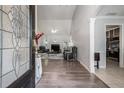 View from the front door into the well-lit living room with vaulted ceilings and hardwood floors at 609 Ashton Manor Dr, Loganville, GA 30052