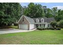 Well maintained two-story home with a two car garage and lush front lawn and landscaping at 609 Ashton Manor Dr, Loganville, GA 30052