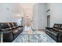 Bright living room with vaulted ceilings, hardwood floors, and decorative fireplace at 609 Ashton Manor Dr, Loganville, GA 30052