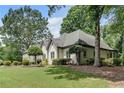 Side view of a well-maintained house with lush landscaping and mature trees surrounding the property at 1285 Rivershyre Pkwy, Lawrenceville, GA 30043