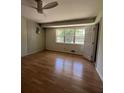 Cozy bedroom featuring a ceiling fan, hardwood floors, and a window with a view of the outdoors at 4376 Riverwood Cir, Decatur, GA 30035