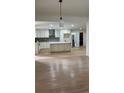 Bright, open kitchen featuring white cabinets, a center island, and modern stainless-steel appliances at 4376 Riverwood Cir, Decatur, GA 30035