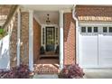Inviting brick-paved front porch with elegant pillars and a stylish black front door at 5492 Glenridge Dr # 536, Atlanta, GA 30342